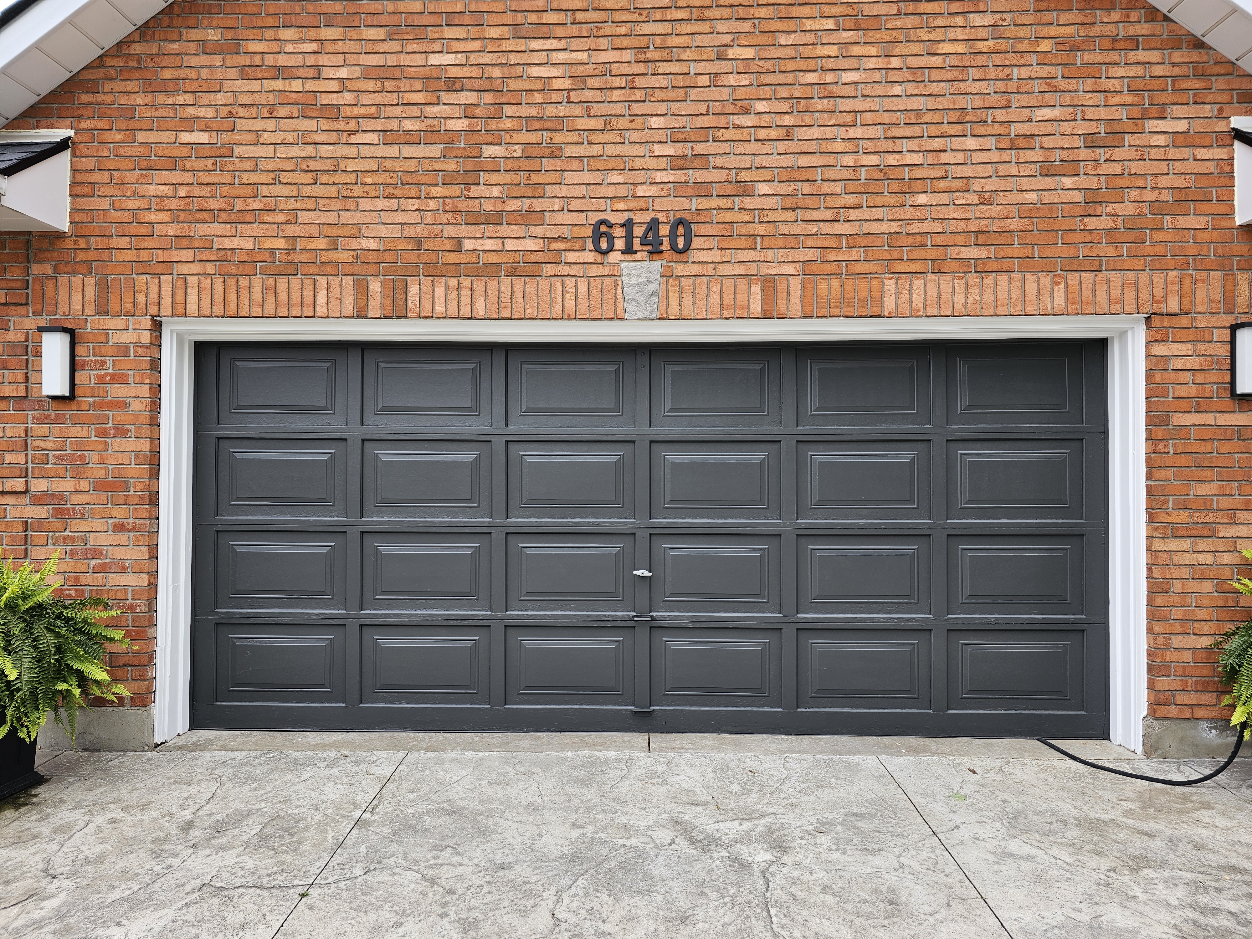 garage door painted black with white trim