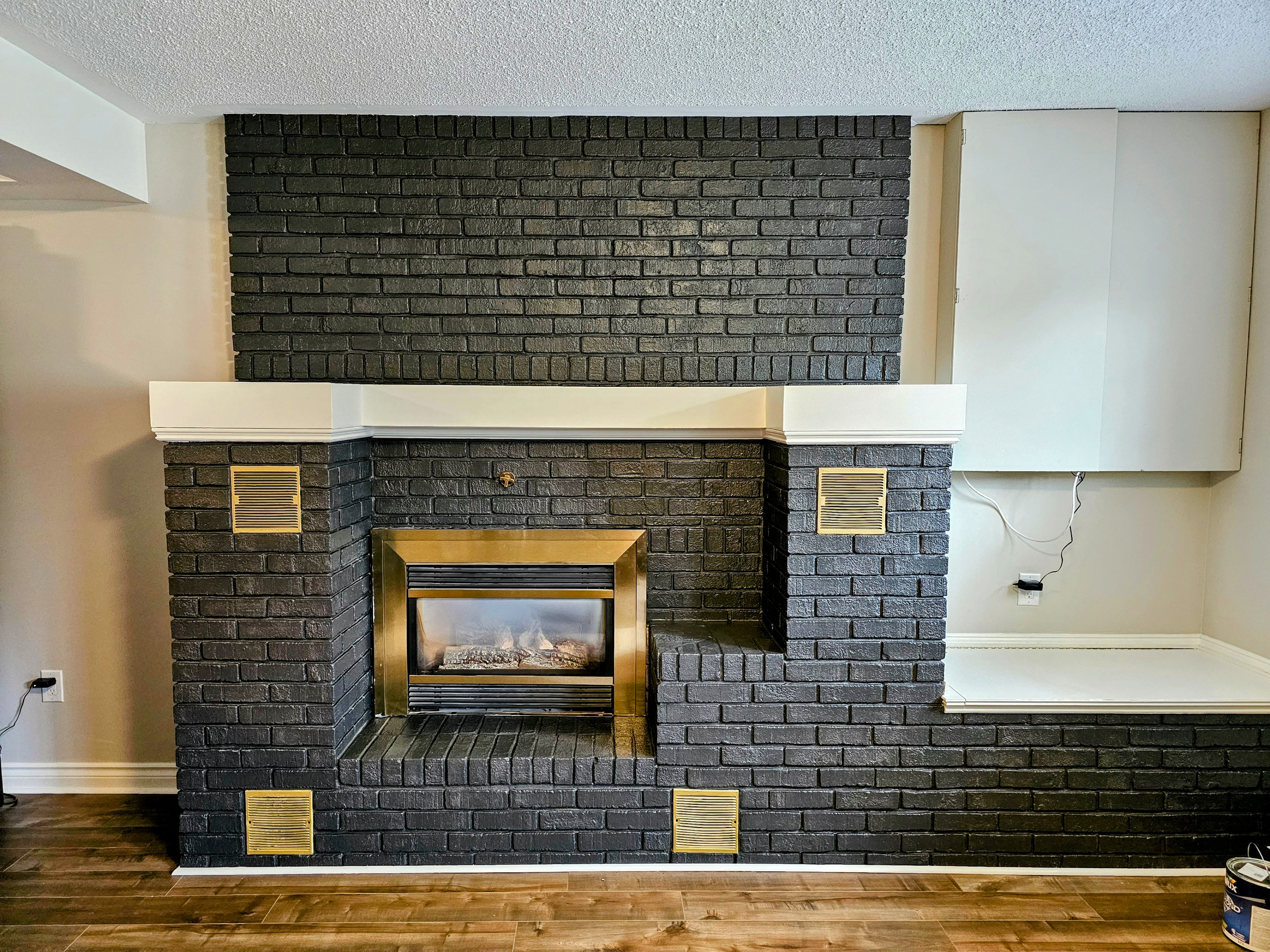 freshly painted brick fireplace in black